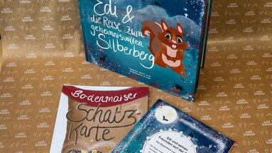 Das Bodenmaiser Kinderbuch "Edi und die Reise zum geheimnisvolle Reise zum Silberberg" mit Schatzkarte Produktfoto. | © Bodenmais Tourismus & Marketing GmbH